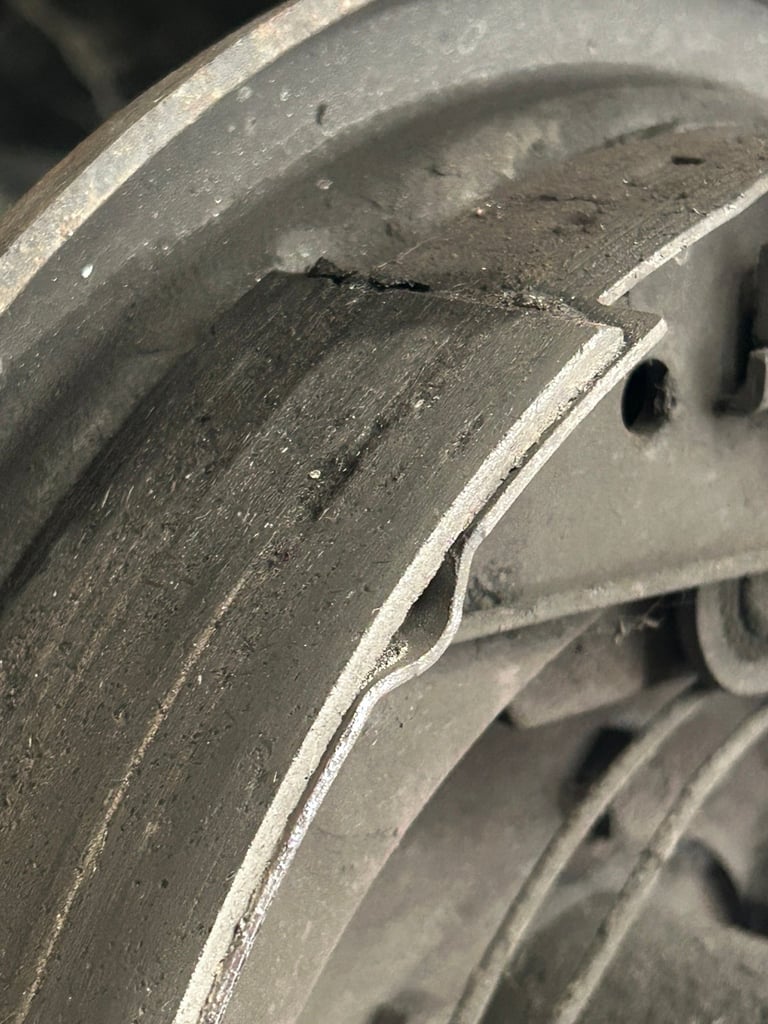 Close-up of a worn metal wheel rim showing scratches and scuff marks on the surface