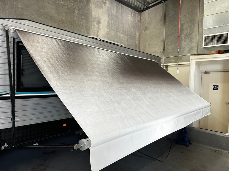 White truck bed cover or tonneau cover extended open in a garage workshop setting