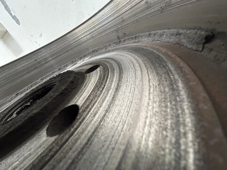 Close-up of worn vehicle tire showing tread patterns and surface wear on rubber compound